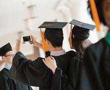 A group of people in graduation attire taking pictures.