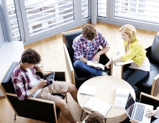 A group of people sitting around each other.