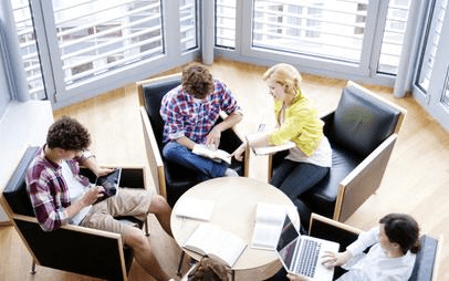 A group of people sitting around each other.