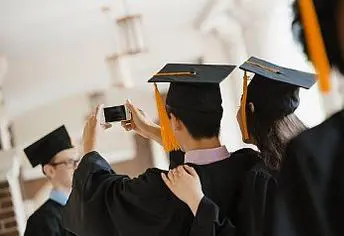 A group of people in graduation gowns taking pictures.