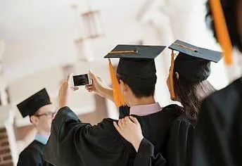 A group of people in graduation gowns taking pictures